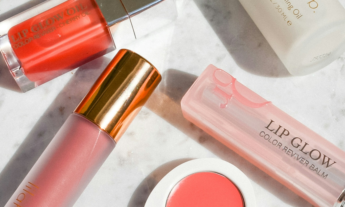 a marble counter top with various beauty products on it