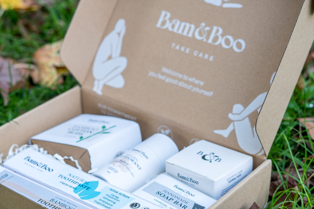 A box of bamboo soaps sitting on the grass