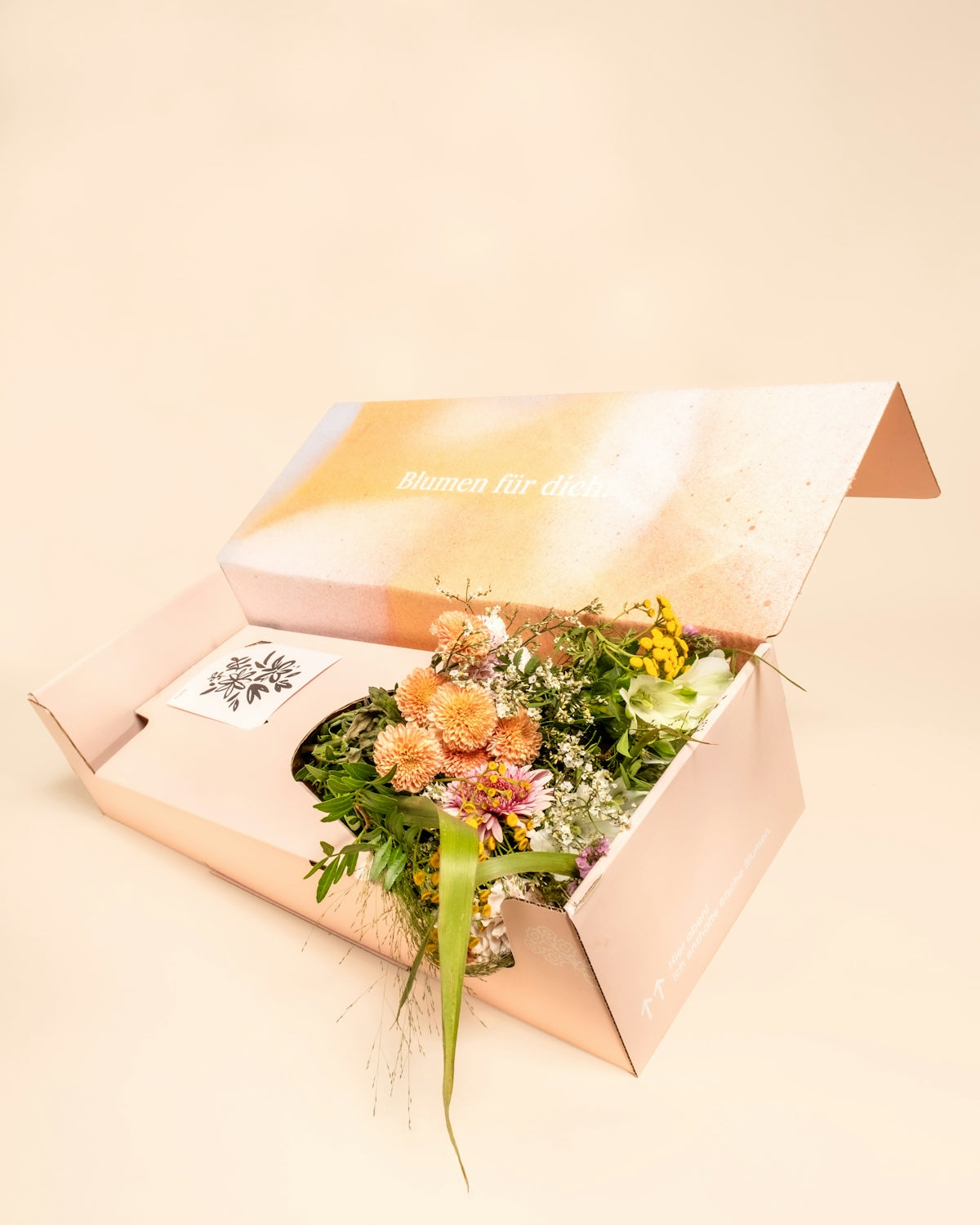 A bouquet of flowers in an open box