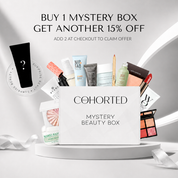 Cohorted First Edition Mystery Beauty Box gift set with assorted skincare and makeup products in a sleek box.